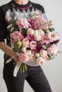 Beautiful luxury bouquet of mixed flowers in woman hand. the work of the florist at a flower shop. A small family Royalty Free Stock Photo