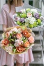 Two beautiful luxury bouquet of mixed flowers in woman hand. the work of the florist at a flower shop. A small family Royalty Free Stock Photo