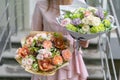 Two beautiful luxury bouquet of mixed flowers in woman hand. the work of the florist at a flower shop. A small family Royalty Free Stock Photo