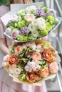 Two beautiful luxury bouquet of mixed flowers in woman hand. the work of the florist at a flower shop. A small family Royalty Free Stock Photo