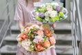 Two beautiful luxury bouquet of mixed flowers in woman hand. the work of the florist at a flower shop. A small family Royalty Free Stock Photo