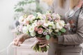 Beautiful luxury bouquet of mixed flowers in woman hand. the work of the florist at a flower shop. Wedding Royalty Free Stock Photo