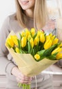 Beautiful luxury bouquet of yellow tulips flowers in woman hand. the work of the florist at a flower shop. cute lovely Royalty Free Stock Photo