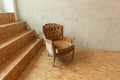 Beautiful luxury classic biege clean interior room in grunge style with brown baroque armchair. Vintage antique brown-gray chair Royalty Free Stock Photo