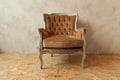 Beautiful luxury classic biege clean interior room in grunge style with brown baroque armchair. Vintage antique brown-gray chair Royalty Free Stock Photo