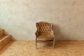 Beautiful luxury classic biege clean interior room in grunge style with brown baroque armchair. Vintage antique brown-gray chair Royalty Free Stock Photo