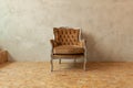 Beautiful luxury classic biege clean interior room in grunge style with brown baroque armchair. Vintage antique brown-gray chair Royalty Free Stock Photo