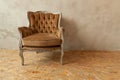 Beautiful luxury classic biege clean interior room in grunge style with brown baroque armchair. Vintage antique brown-gray chair Royalty Free Stock Photo