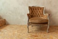 Beautiful luxury classic biege clean interior room in grunge style with brown baroque armchair. Vintage antique brown Royalty Free Stock Photo