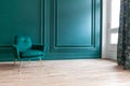 Beautiful luxury classic blue green clean interior room in classic style with green soft armchair. Vintage antique blue