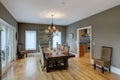 Beautiful luxury diningroom with wood and wicker chairs and hardwood floors and table