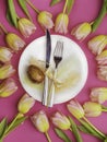 Easter table cutlery with tulips, eggs, feathers Royalty Free Stock Photo