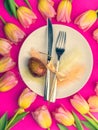 Easter table cutlery with tulips, eggs, feathers Royalty Free Stock Photo