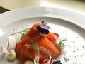 Beautiful luxury plate Appetizer smoked salmon salad with caviar black with drill and edible flower. Royalty Free Stock Photo