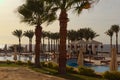 Beautiful luxury swimming pool with palm trees and stunning view of Red Sea. Summer vacation concept. Sharm El Sheikh, Egypt Royalty Free Stock Photo