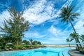 Beautiful luxury umbrella and chair around outdoor swimming pool in hotel and resort with coconut palm tree on blue sky Royalty Free Stock Photo