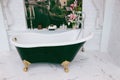 Beautiful luxury vintage empty bathtub near big window in bathroom interio, free space.