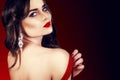 Beautiful luxury woman with jewelry, earrings. Beauty and accessories. brunette girl with big red lips in a red dress.