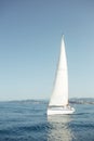 Yacht with white sails on the calm sea in good sunny day.