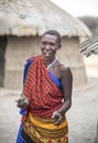 Beautiful maasai woman with cow tang on her hands that she used to build her house