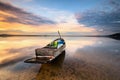 Beautiful majestic sunrise by the lakeside with fishing boat