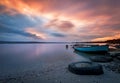 Beautiful majestic sunrise by the lakeside with fishing boats. Royalty Free Stock Photo