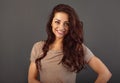 Beautiful makeup toothy enjoying smiling woman with long brown healthy curly hair style in fashion shirt clothing. Closeup studio Royalty Free Stock Photo