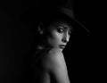 Beautiful makeup woman with elegant healthy neck, nude back and shoulder on black background in fashion hat with empty copy space Royalty Free Stock Photo