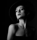 Beautiful makeup woman with elegant healthy neck, nude back and shoulder on black background in fashion hat with empty copy space Royalty Free Stock Photo