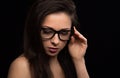 Beautiful makeup woman in eye glasses looking down with long hair on black background. Closeup portrait. Art.Expression Royalty Free Stock Photo