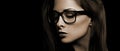 Beautiful makeup woman in eye glasses looking down with long hair on black background. Closeup portrait. Art.Profile view Royalty Free Stock Photo