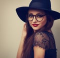 Beautiful makeup woman in fashion black hat and eyeglasses looking with smiling. Toned closeup portrait