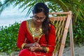 Beautiful maldivian woman in national dress crafting ropes