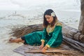 Beautiful maldivian woman in national dress making plates for roof building