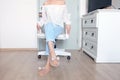 Beautiful male Wearing White Shirt and Blue Jeans Isolated. Stylish Pink Sandal Shoes. Portrait of Woman Sitting on White Chair