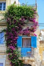 Beautiful Maltese balcony entwined with bougainvillea on Birgu.