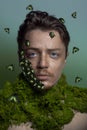 Beautiful man with green bettles on his face portrait background beauty portrait photoshoot Royalty Free Stock Photo