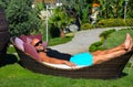 Beautiful man relaxing in a tropical garden Royalty Free Stock Photo