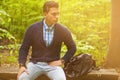 Beautiful man sitting on a bench. summer warm tone Royalty Free Stock Photo