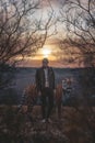 Beautiful man with tiger in sunset nature photoshoot portrait