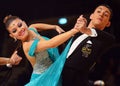 Beautiful man and woman in blue dress perform smiling during dancesport competition Royalty Free Stock Photo