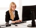 Beautiful manager - business woman works on computer in her of