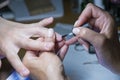 Beautiful manicure process. Nail polish being applied to hand, polish is a blue color. close up