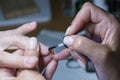 Beautiful manicure process. Nail polish being applied to hand, polish is a blue color. close up