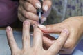 Beautiful manicure process. Nail polish being applied to hand, polish is a blue color. close up