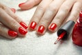 Beautiful manicured woman`s nails with red nail polish on soft white towel. Royalty Free Stock Photo