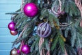 Beautiful Marble-balls hanging on the Christmas tree, shining colorful garland. On the branches covered with snow. Royalty Free Stock Photo