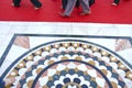 Beautiful marble floor and barefooted sikh prayers foots on red carpet Royalty Free Stock Photo