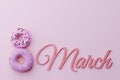 Beautiful 8 march greeting card with donuts in form of eight with pink icing and colorful sprinkles on pink background.