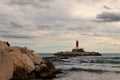 Beautiful maritime sunset with lighthouse at the entrance to the fishing port of Villajoyosa Royalty Free Stock Photo